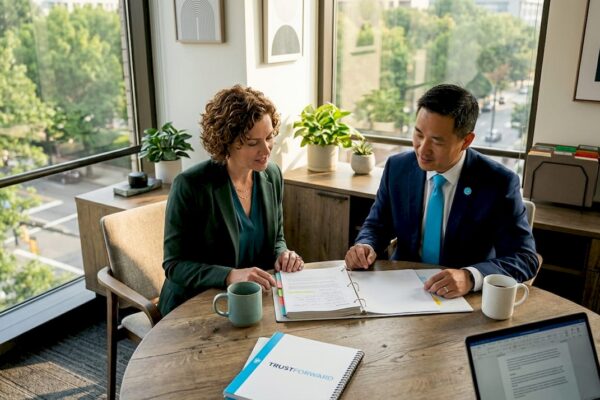 Law firm partners reviewing CSR report at office table